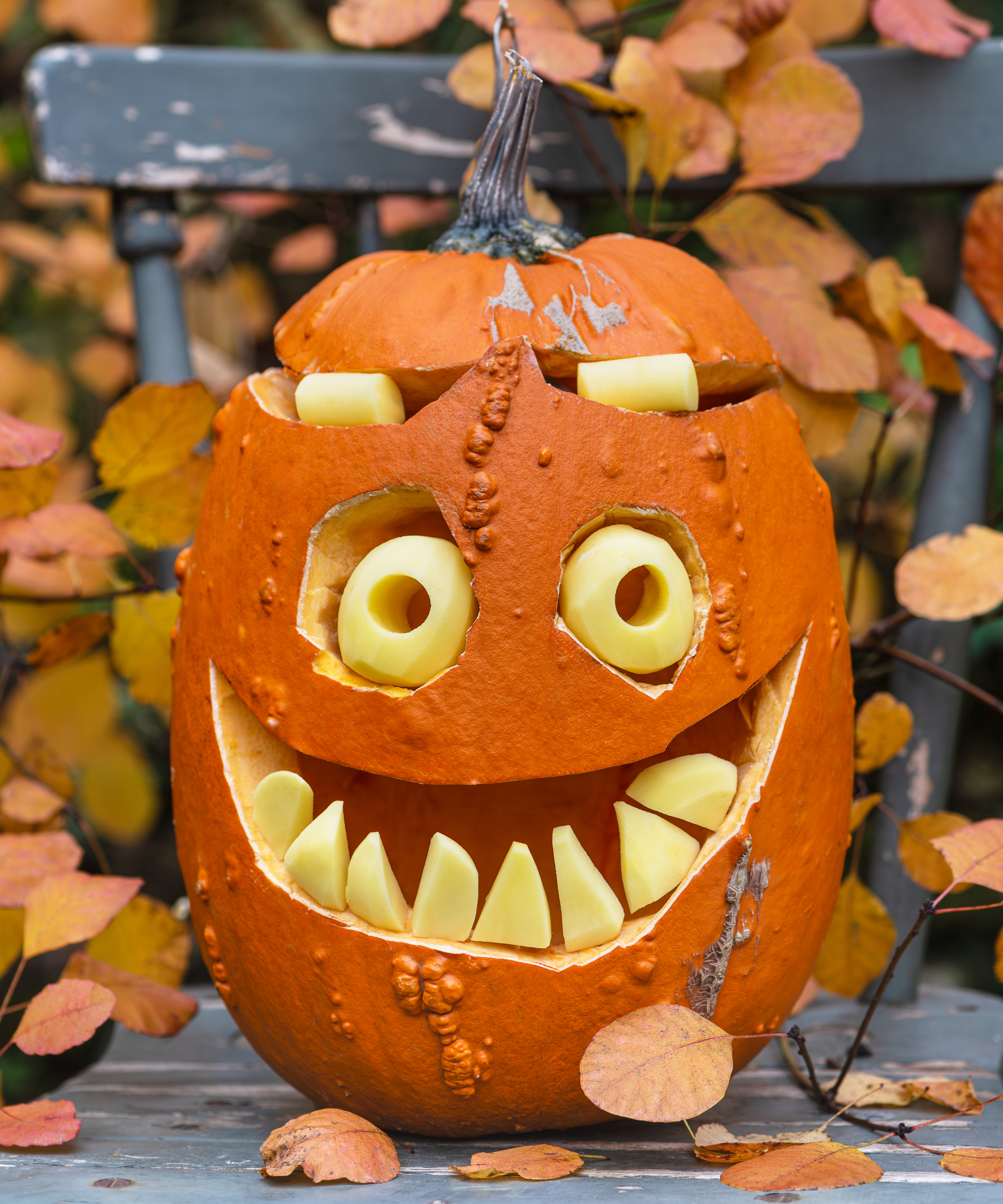 Playful Halloween pumpkin with a comic monster face and big yellow eyes, carved for autumn celebrations. Festive and humorous decoration capturing the fun side of Halloween night.