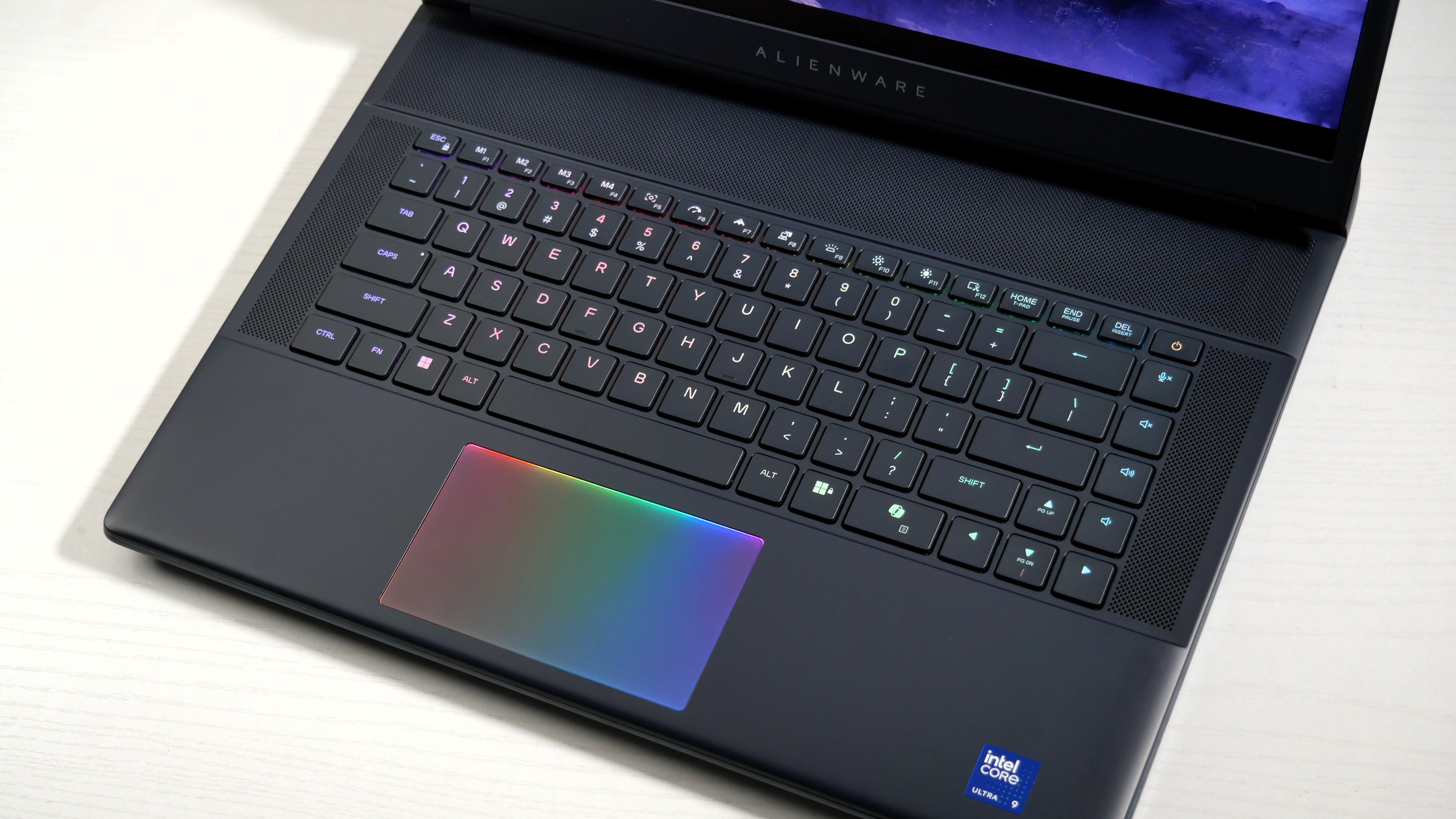 Alienware 16 Area-51 (RTX 5080) open on a desk, highlighting the RGB-lit keyboard and touchpad.