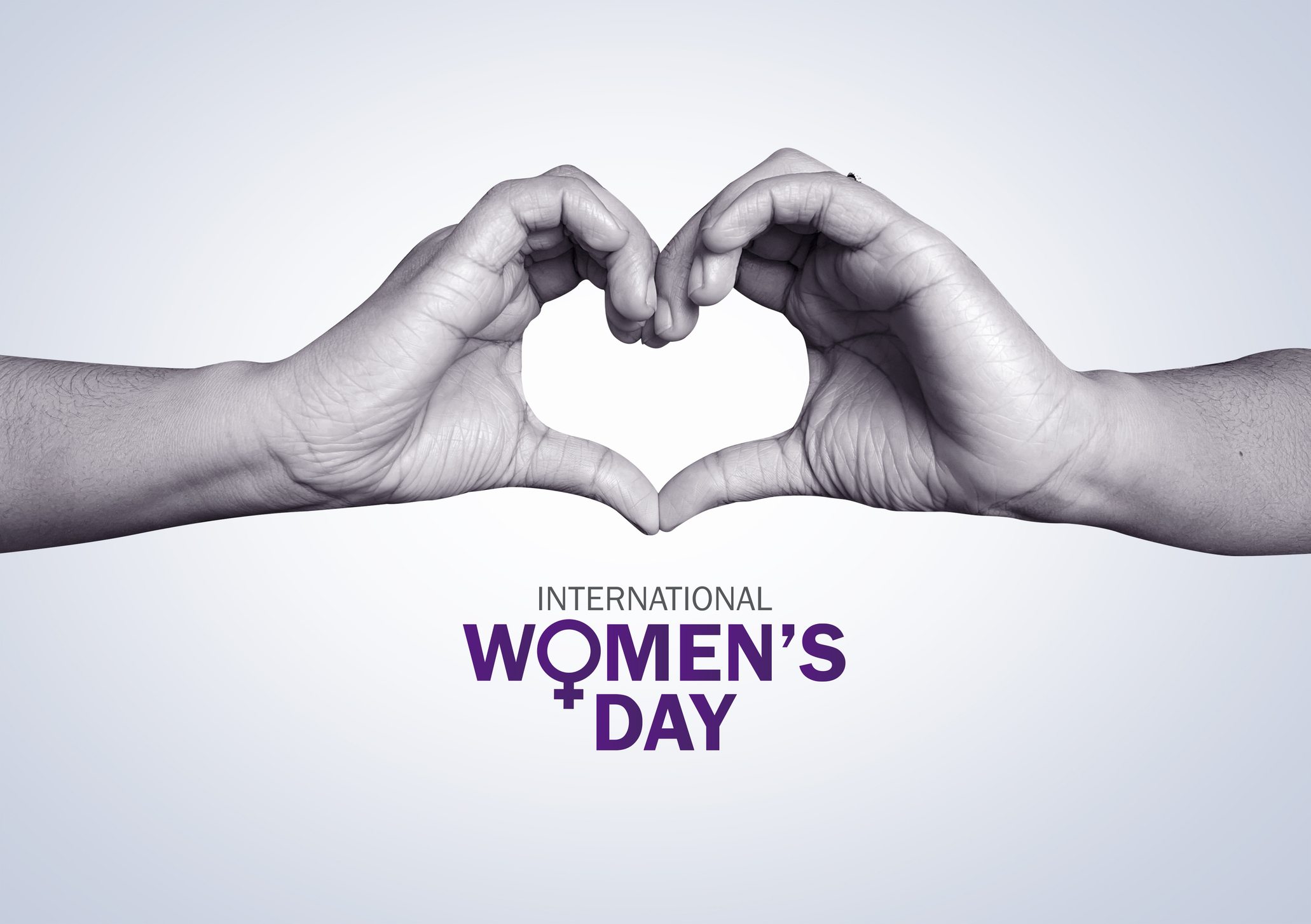 International Women's Day logo with hands forming a heart above it
