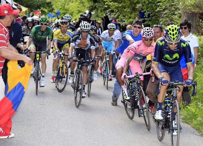 Giro d'Italia leader Nairo Quintana is nearly tackeld by an overzealous fan on the Monte Zoncolan