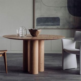 A modern circular dining table made out of wood