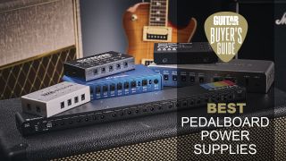 Multiple pedalboard power supplies stacked on top of a guitar amp