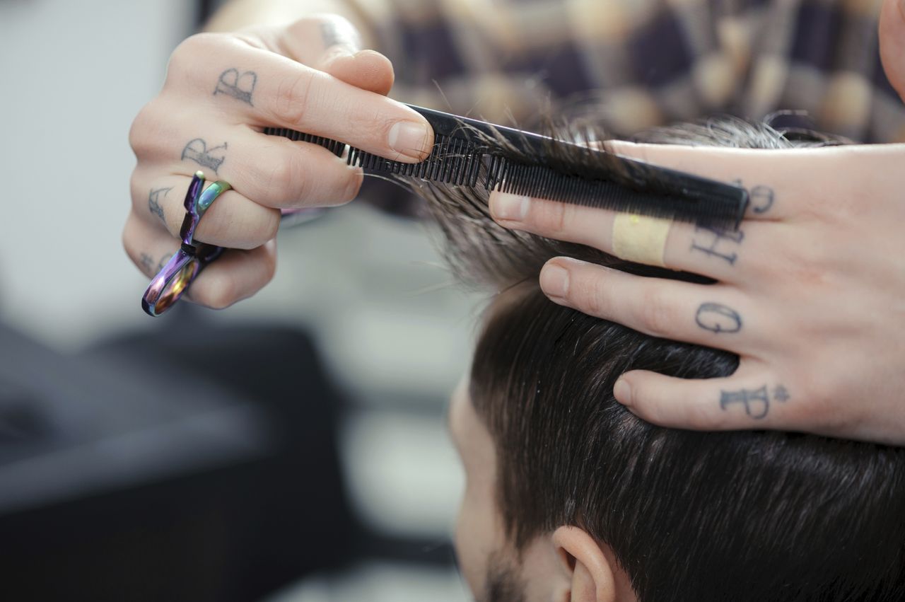 A man getting his hair trimmed