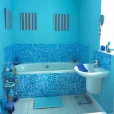 bathroom with blue walls and blue mosaic tiles