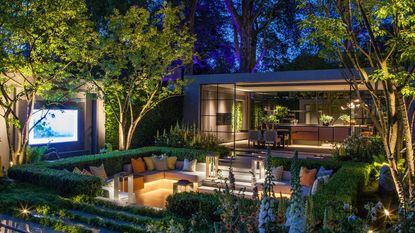 landscaping with lights: john cullen lighting surrounding seating area at Chelsea Flower Show