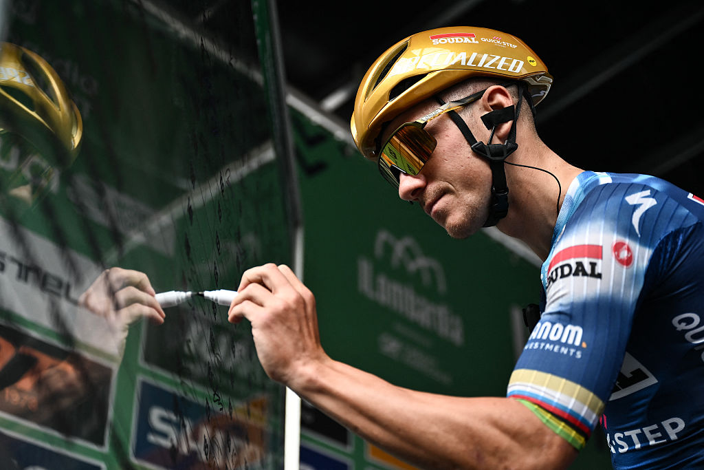 Soudal Quick-Step&rsquo;s Belgian rider Remco Evenepoel signs in, ahead of the 119th edition of the Giro di Lombardia (Tour of Lombardy), a 238km cycling race from Como to Bergamo on October 11, 2025. (Photo by Marco BERTORELLO / AFP)