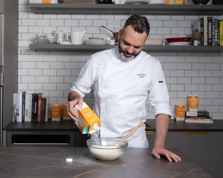 chef dominique ansel pouring flour into a bowl