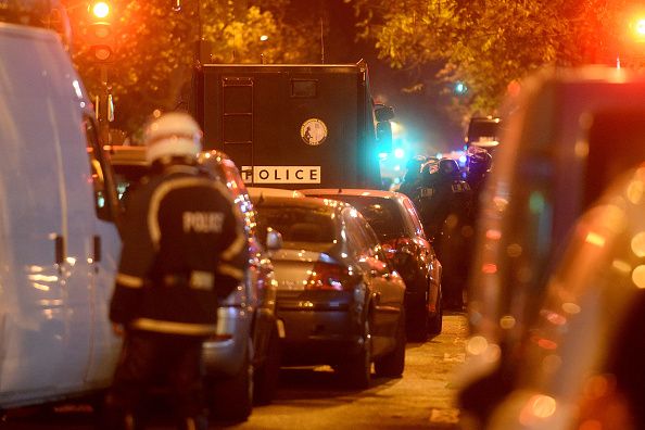 Policemen patrol the streets during gunfire near the Bataclan concert hall 