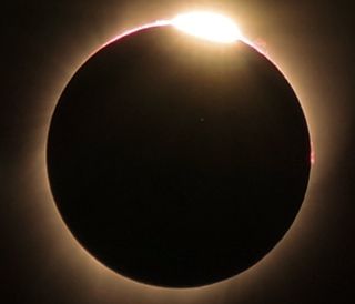 In this view of the solar eclipse of Aug. 21, 2017, captured from Wyoming, a solar flare is visible on the upper right quadrant of the sun's surface.