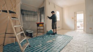 Renovation and repaint. The worker is repairing the old house.