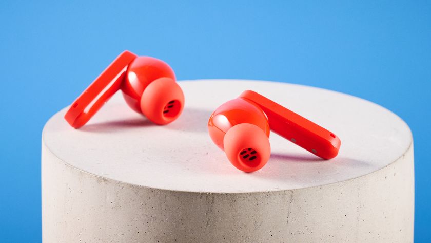 the nothing cmf buds pro 2 cmf by nothing buds pro 2 in bright orange shown in the smart dial charging case against a blue tom's guide background