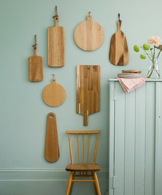 room with sky blue wall wood chopping board and wood chair