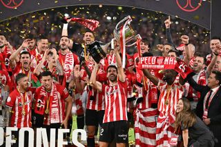 Athletic Club players celebrate with the trophy after their Copa del Rey final win over Mallorca in April 2024.