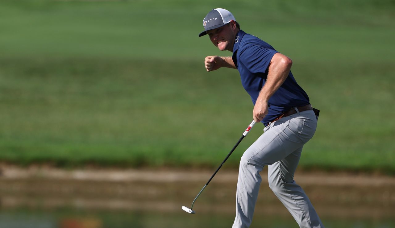 Mullinax fist pumps after holing a birdie putt to win