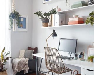Neutral office with white shelves on wall