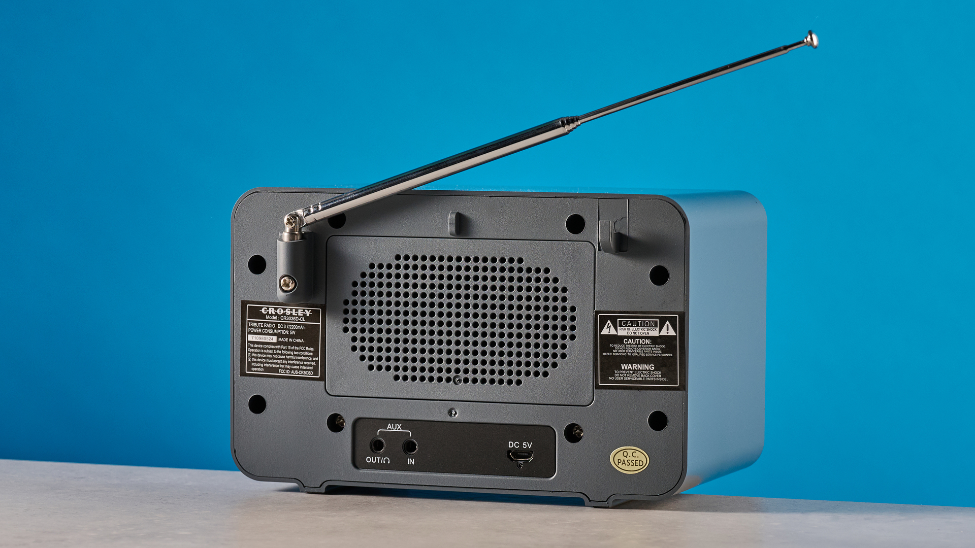 Crosley Tribute Radio in gray color photographed on a blue background