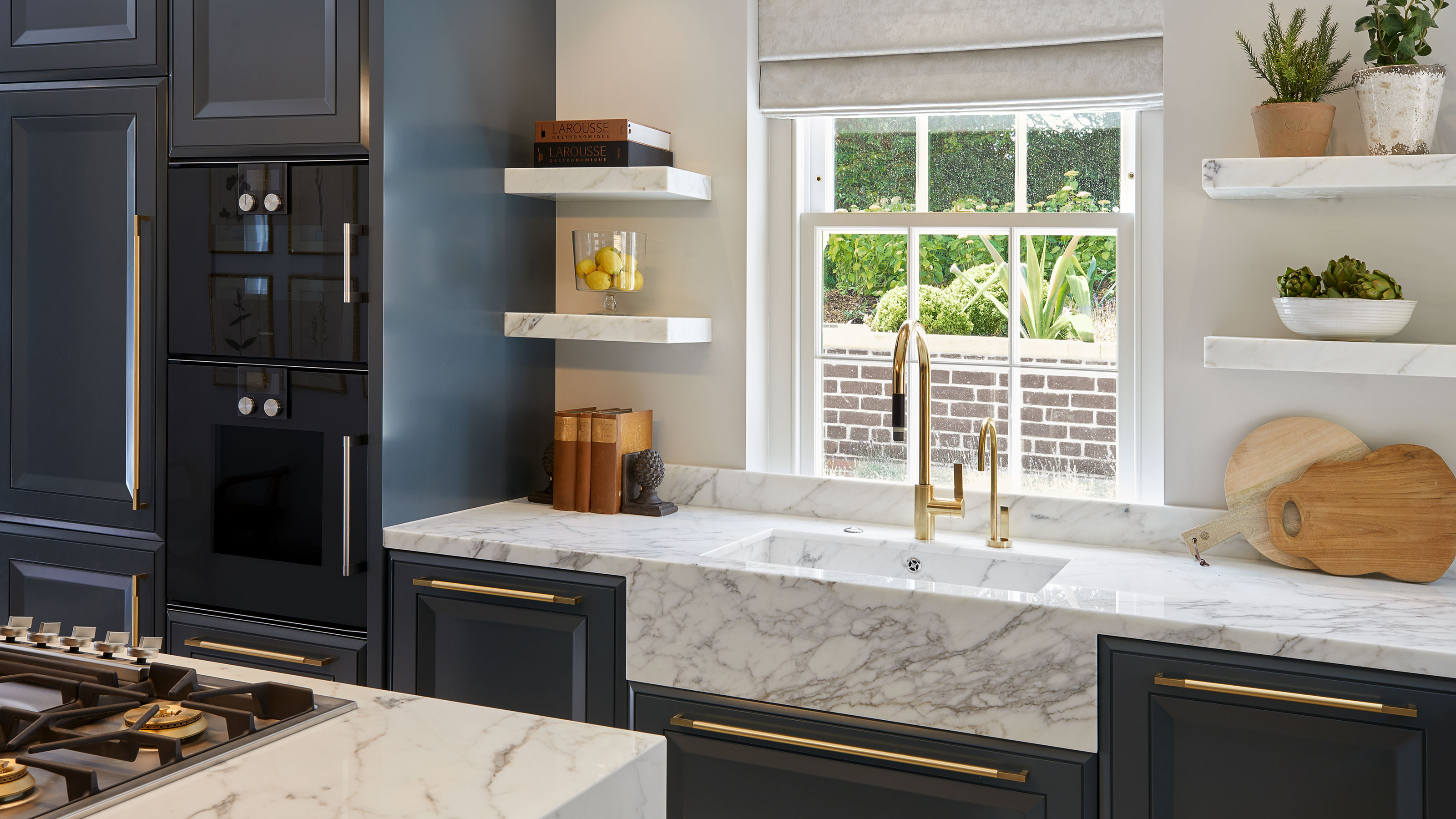 blue Shaker kitchen with composite worktops and kitchen sink with brass taps