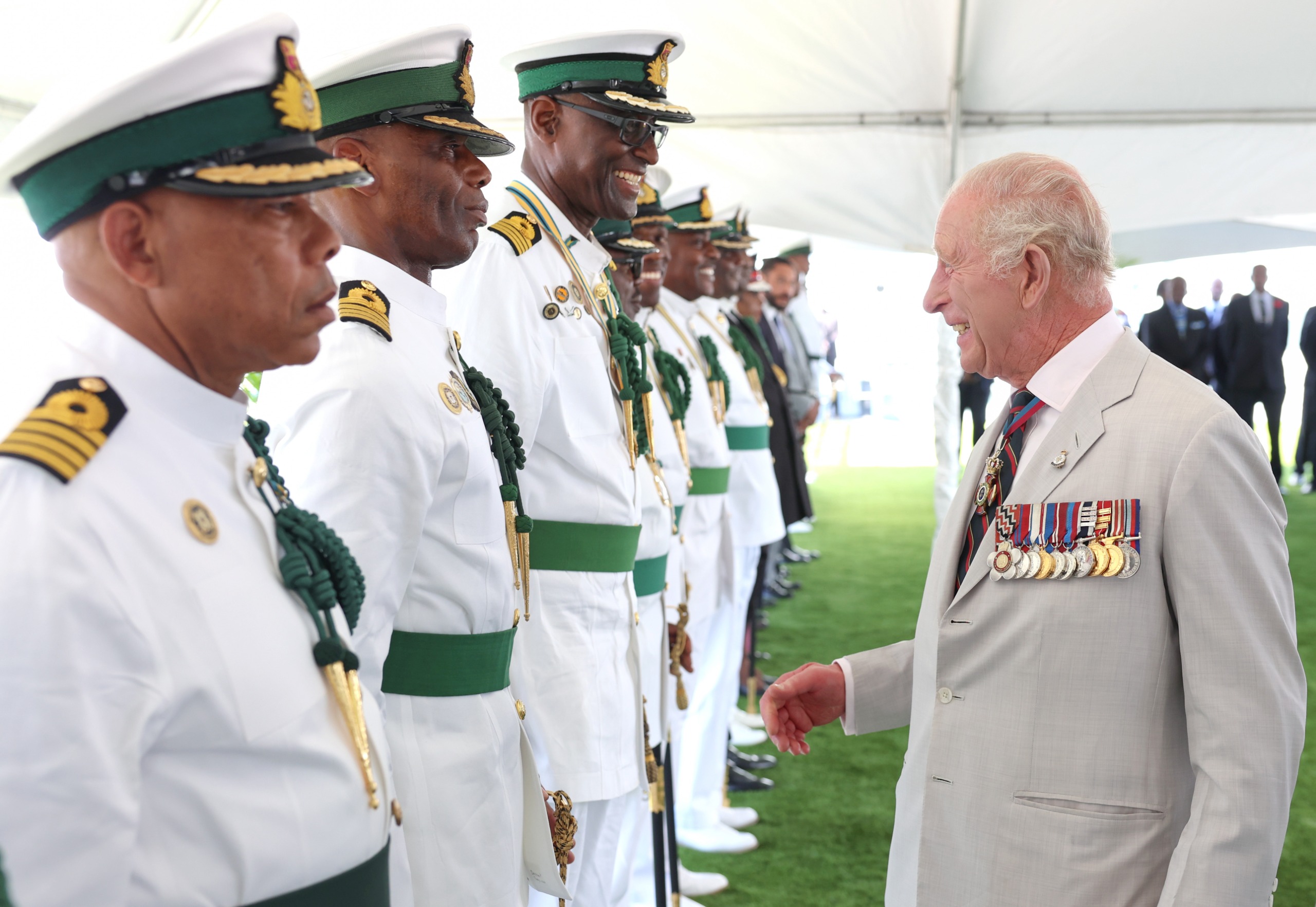 King Charles talking to soldiers and laughing in the Bahamas