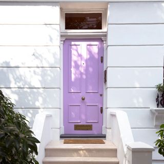 main entrance with purple door and white walls