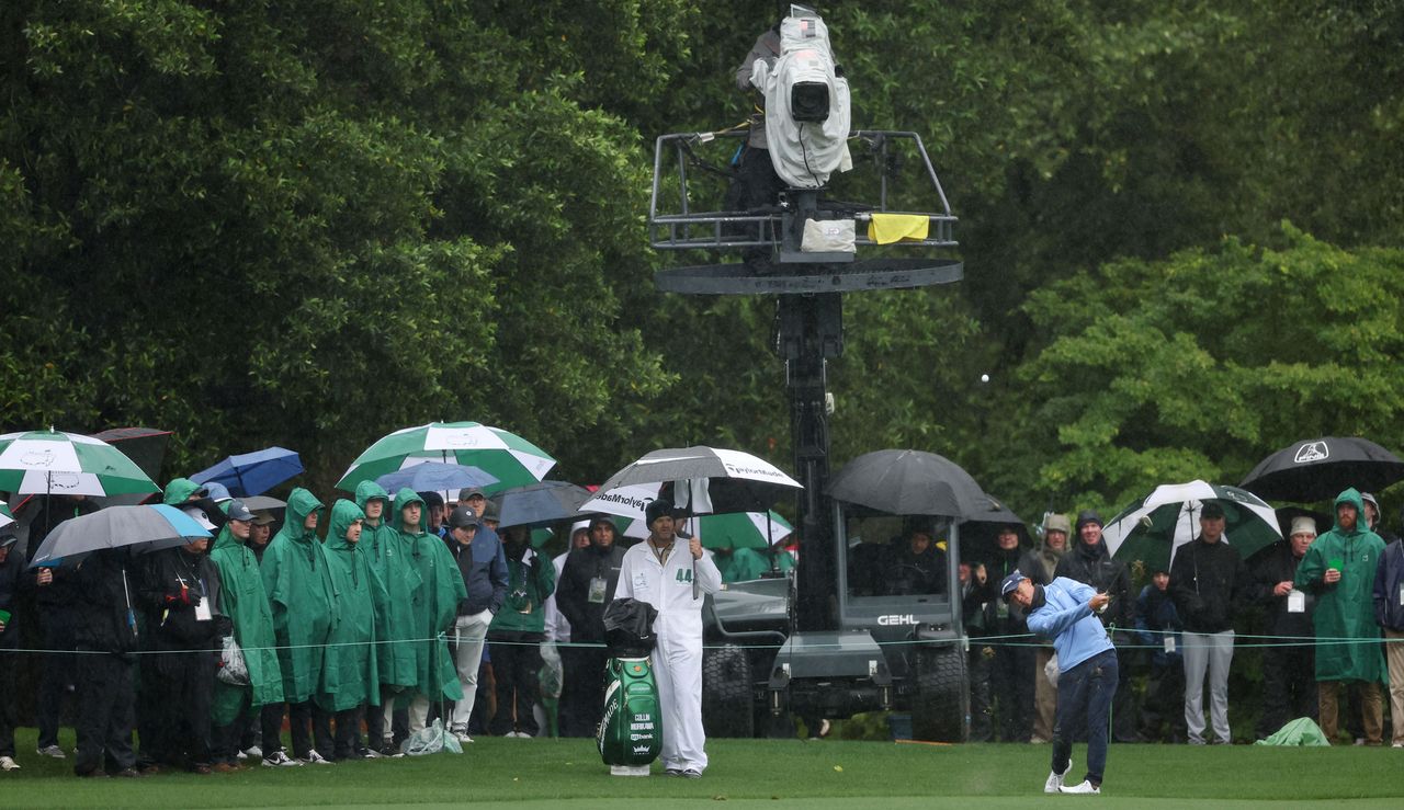 Collin Morikawa tees off whilst patrons watch on