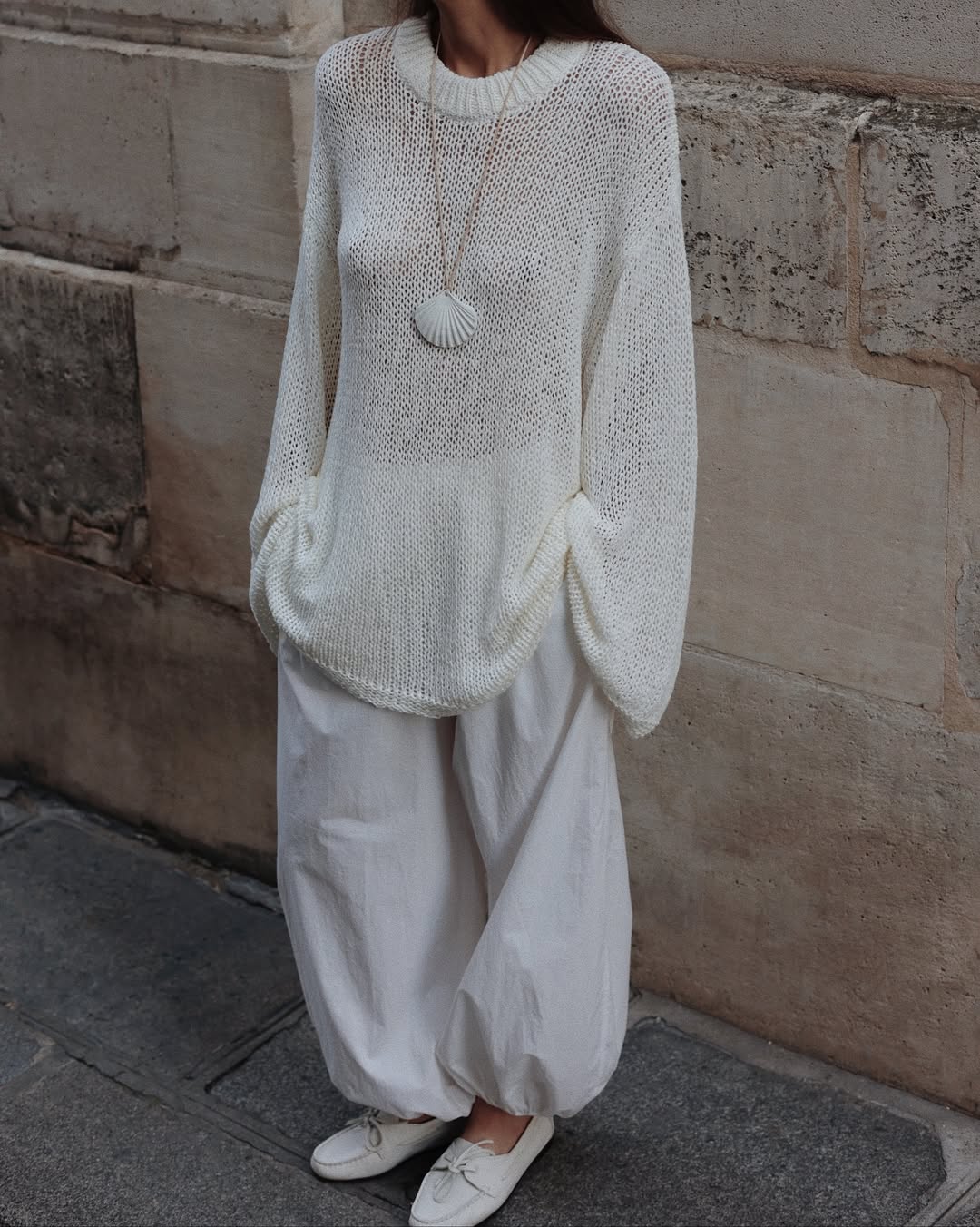 Woman in balloon pants and a white sweater