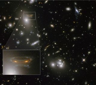 Galaxy cluster Abell 68 contains a spiral galaxy at upper left that resembles an alien from the video game Space Invaders. Image released March 5, 2013.