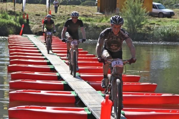 Riders cross a bridge in the Real Insurance XCM