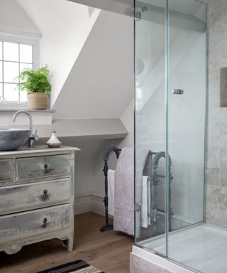 Bathroom with a vintage dresser upcycled into a bathroom vanity