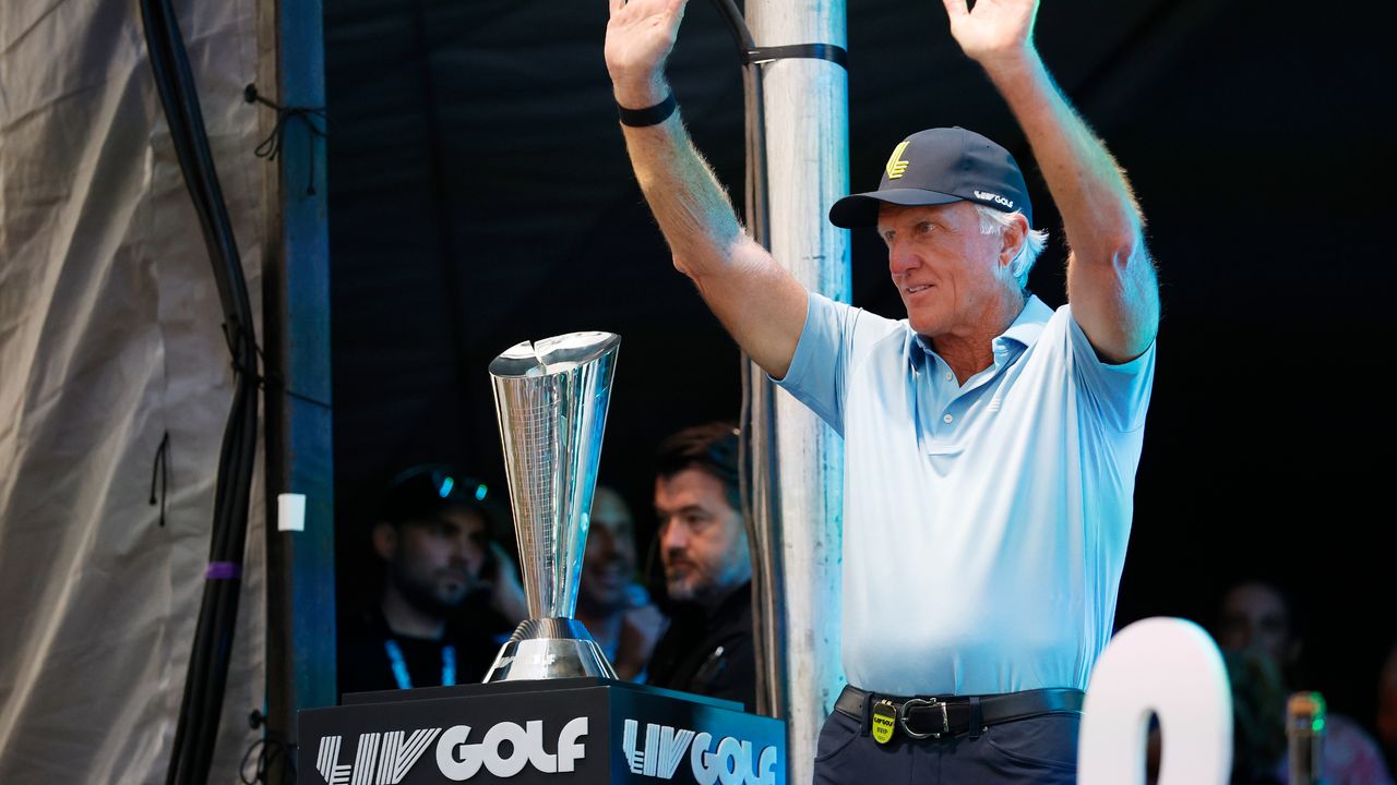 Greg Norman with the LIV Golf Team Championship trophy