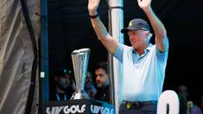 Greg Norman with the LIV Golf Team Championship trophy