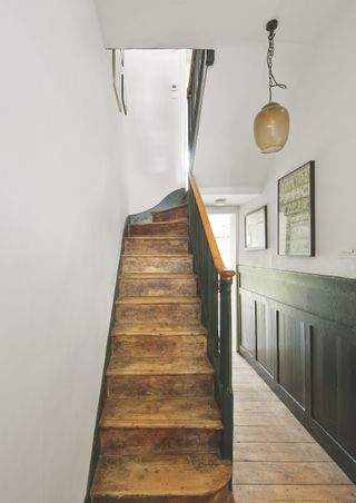 modern renovated hallway with wooden stairway without carpet