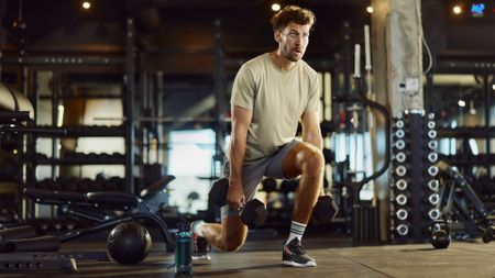 A man performing dumbbell lunges