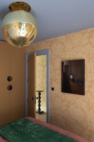 A bedroom with a gold light