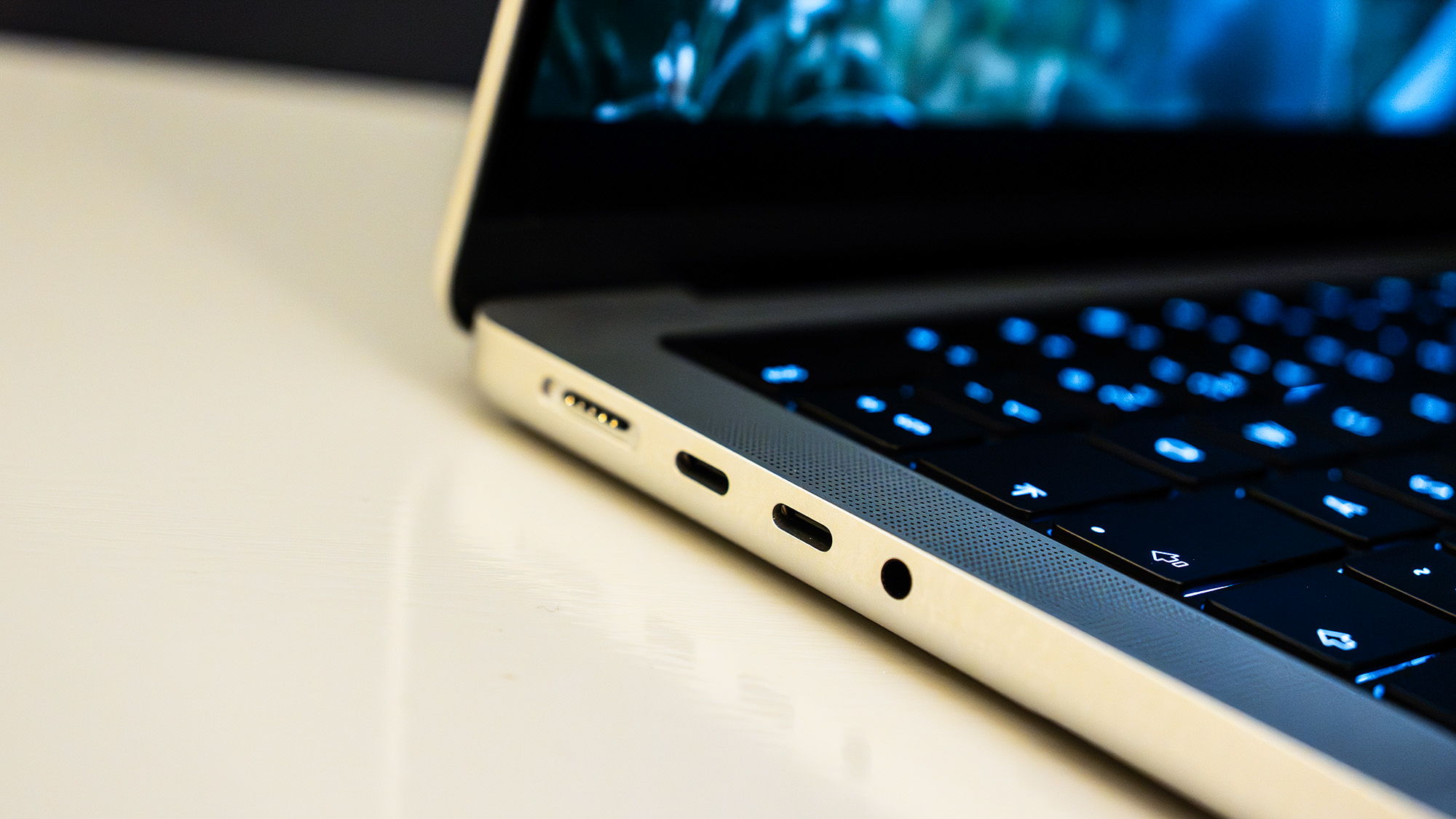 Apple MacBook Pro 14 (M5 Max) on a white table in front of a black wall
