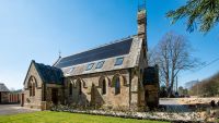 A church converted to Passivhaus standards with solar panels on the roof