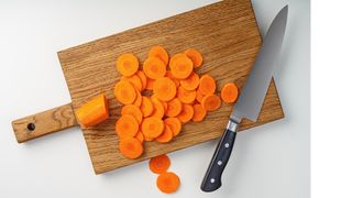 Chopping board with carrots on