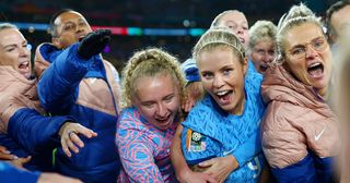 Katie Robinson, Rachel Daly and teammates of England huddle with Sarina Wiegman, Manager of England, following the FIFA Women's World Cup Australia & New Zealand 2023 Semi Final match between Australia and England at Stadium Australia on August 16, 2023 in Sydney, Australia.