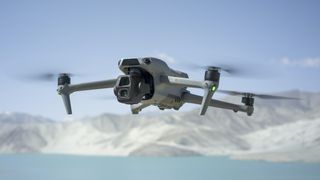 DJI Air 3S in flight with snow capped mountain backdrop