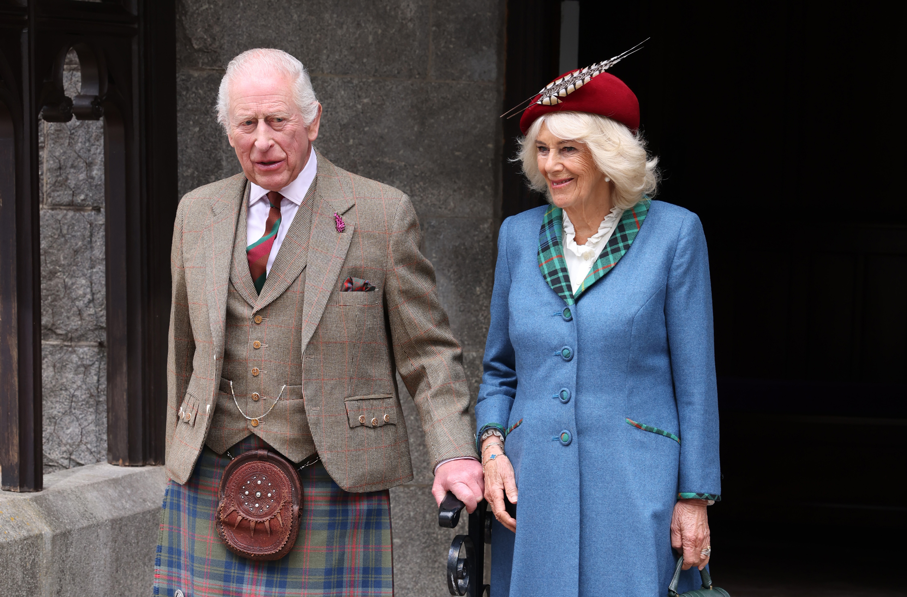 King Charles and Queen Camilla wearing tartan outside Crathie Kirk in Scotland