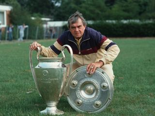 Ernst Happel poses with the Bundesliga shield and the European Cup at Hamburg in 1983.