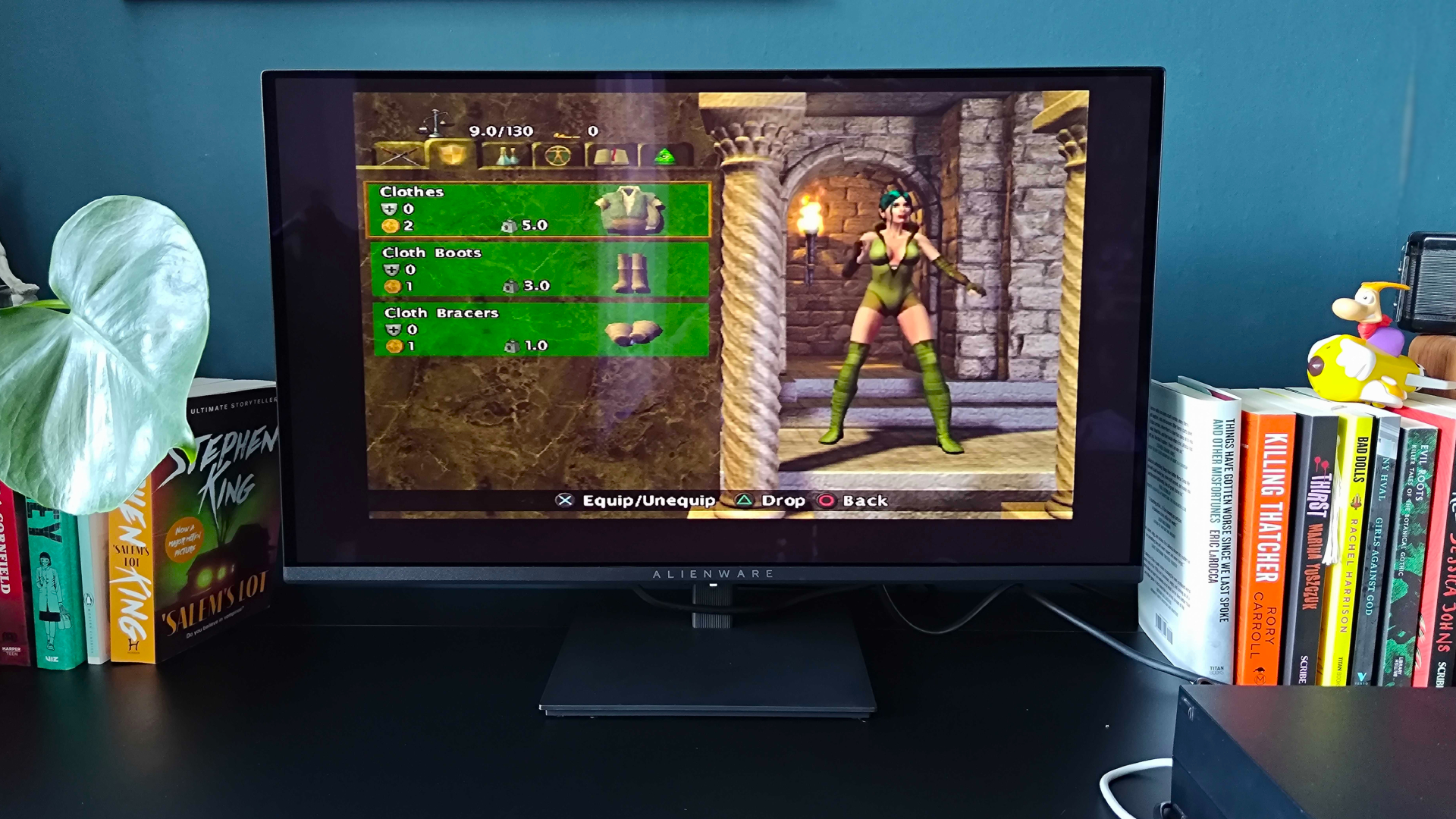 Alienware AW2726DM monitor on black desk with PS2 connected via upscaler and Baldur's Gate Dark Alliance gameplay on screen.