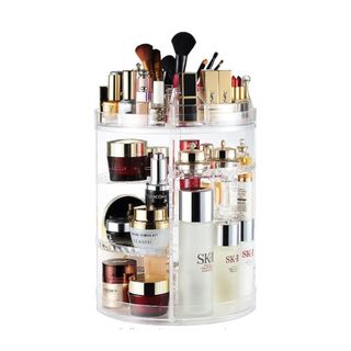 A tall makeup organizer with makeup and skincare products on it