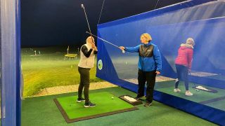Emma Booth teaching a female golfer