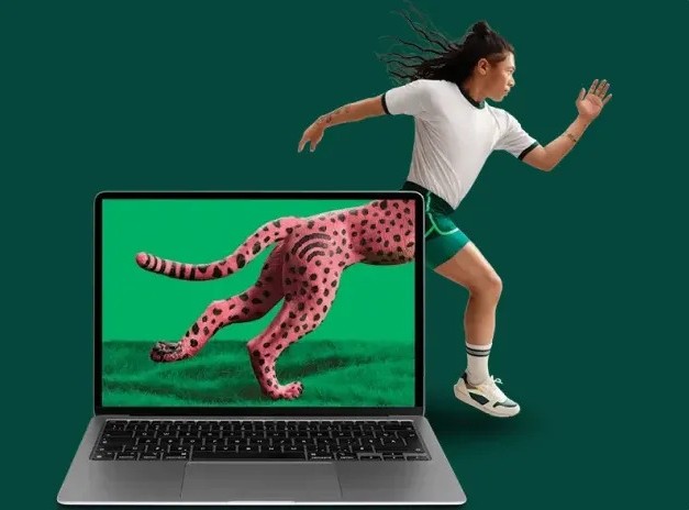 A runner running behind a laptop screen showing a cheetah