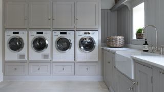 Bank of cabinets with two washing machines and two tumble dryers