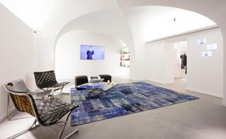 In the basement, the building's historical vaults have been transformed into a bright white space