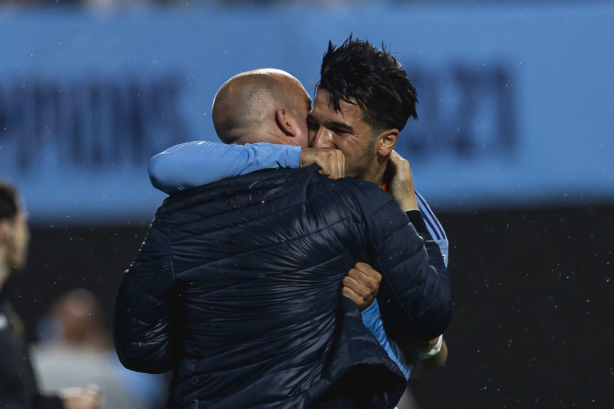 Mounsef Bakrar embraces his manager Nick Cushing on the touchline after scoring for New York City FC
