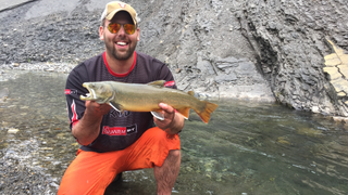 Jeremy Evans holding a trout