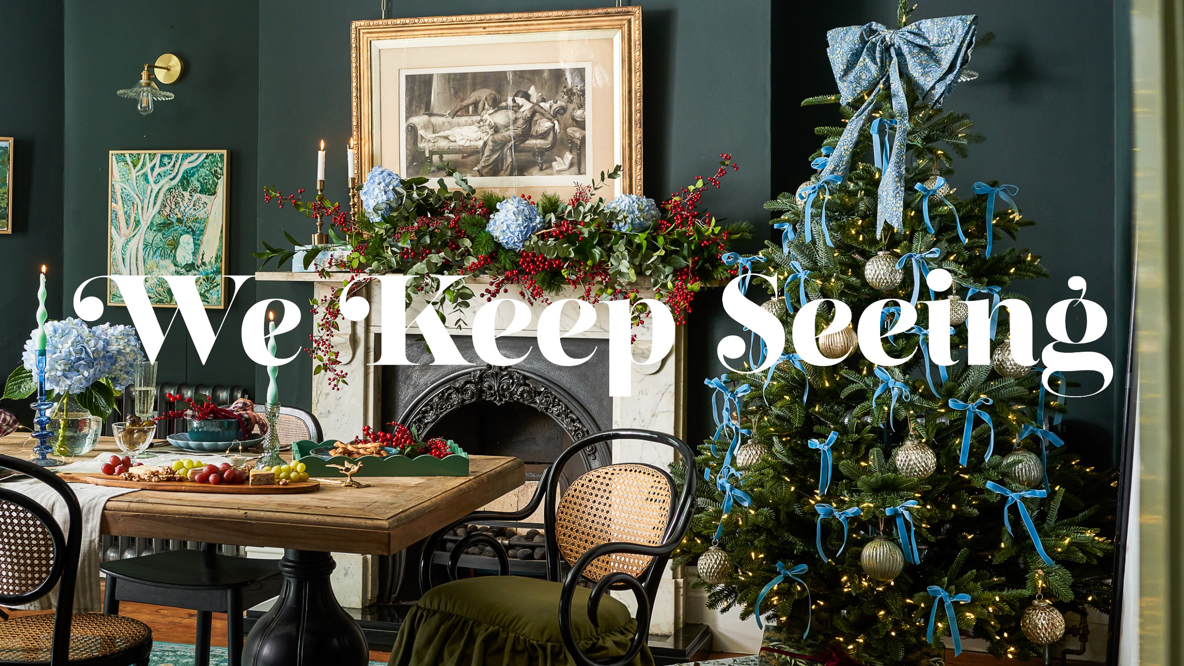 A dining room with a Christmas decorated with blue bows and the table set with a cheese board