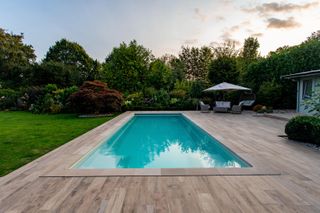 XL Pools outdoor pool with decking and parasol